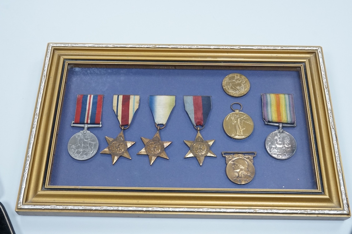 Framed group of eight WWI and WWII medals including a First World War medal pair, the Africa star, the Atlantic star, etc. a hallmarked silver boxing medal and another, both cased, plus a Lancashire and Cheshire Associat